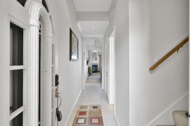 hallway featuring light tile patterned floors and ornamental molding