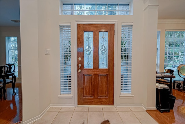 tiled entryway with crown molding