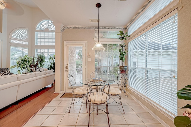 sunroom / solarium featuring ceiling fan