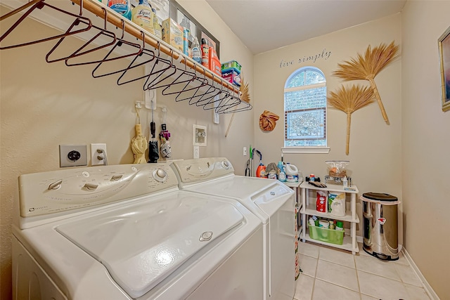 laundry area with light tile patterned floors and washing machine and clothes dryer