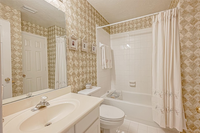 full bathroom with vanity, shower / bath combination with curtain, tile patterned flooring, toilet, and a textured ceiling