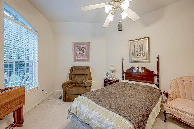 bedroom with ceiling fan, light colored carpet, and vaulted ceiling