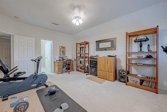 workout area with carpet flooring and vaulted ceiling