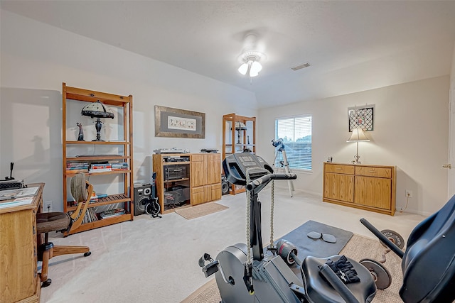 exercise area with light carpet and lofted ceiling