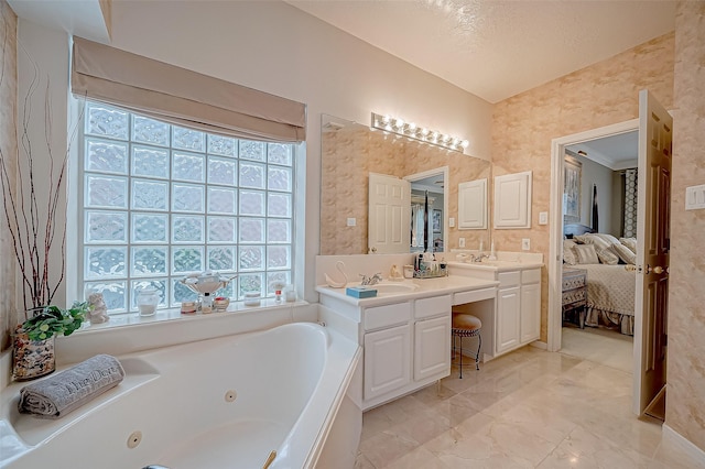 bathroom with a bathing tub, vanity, and a textured ceiling