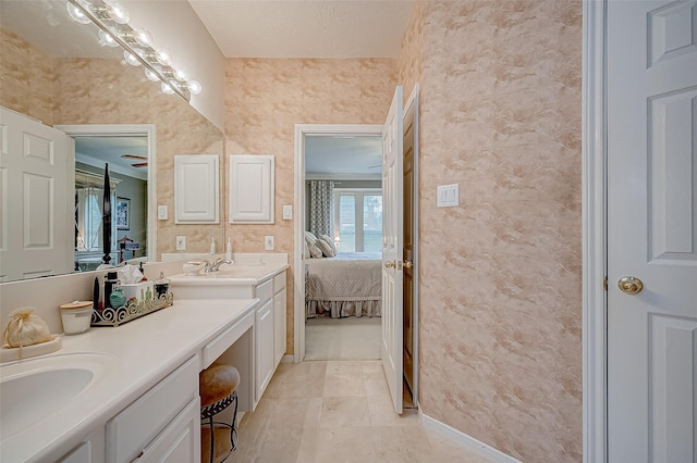 bathroom with vanity, a textured ceiling, and ornamental molding