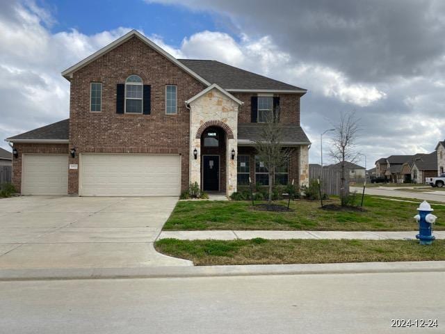 view of front of house with a front yard and a garage