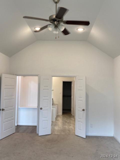 unfurnished bedroom with ceiling fan, lofted ceiling, and carpet floors