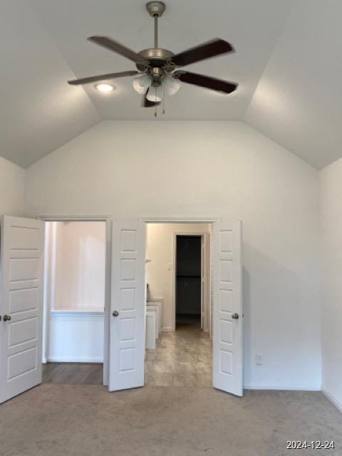 unfurnished bedroom featuring ceiling fan, carpet floors, and vaulted ceiling