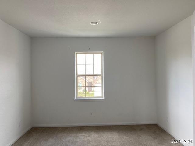 unfurnished room featuring light colored carpet