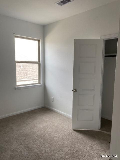 unfurnished bedroom featuring a closet and carpet