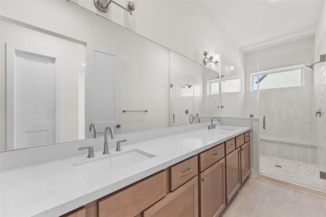 bathroom with vanity, tile patterned floors, and a shower with door