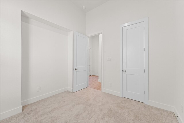 unfurnished bedroom with light colored carpet