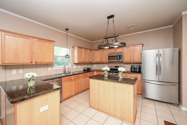 kitchen featuring sink, a center island, pendant lighting, and appliances with stainless steel finishes