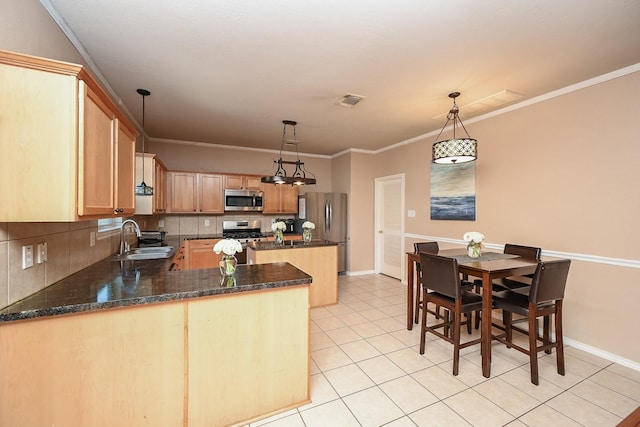 kitchen with pendant lighting, stainless steel appliances, ornamental molding, and sink