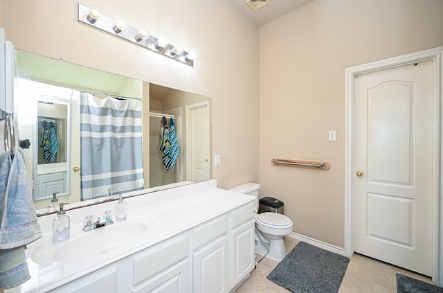 bathroom featuring toilet, vanity, tile patterned floors, and walk in shower