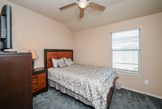 carpeted bedroom featuring multiple windows, vaulted ceiling, and ceiling fan