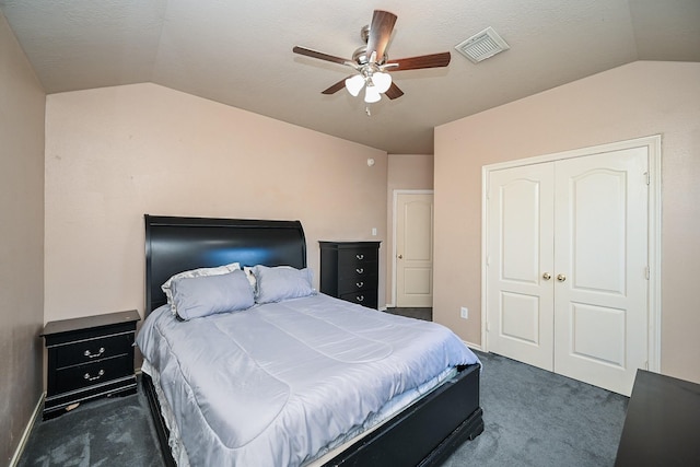 carpeted bedroom with a closet, ceiling fan, and lofted ceiling