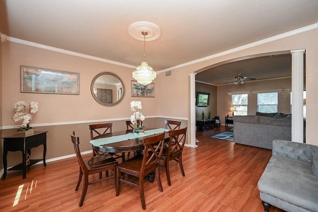 dining area with hardwood / wood-style flooring, ceiling fan with notable chandelier, and ornamental molding