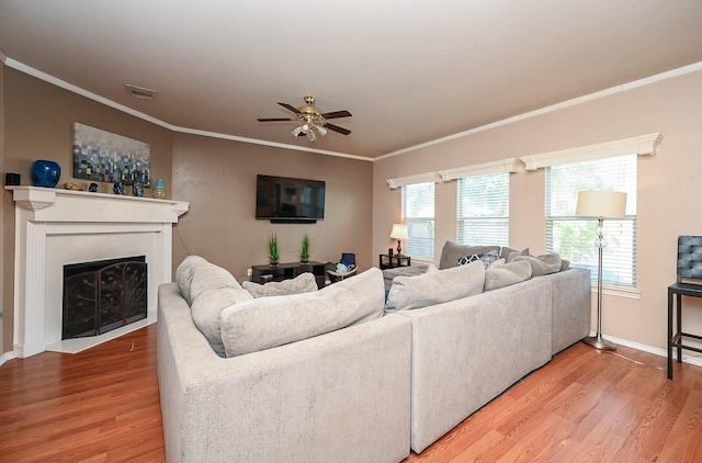 living room featuring ceiling fan, plenty of natural light, and wood-type flooring