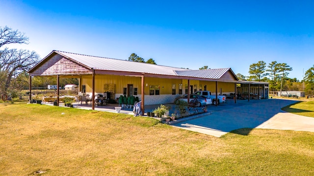 back of property featuring a lawn and a patio