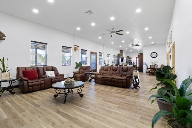 living room featuring ceiling fan and light hardwood / wood-style flooring