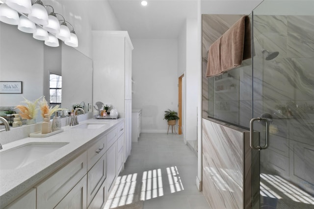 bathroom featuring tile patterned flooring, vanity, and a shower with door