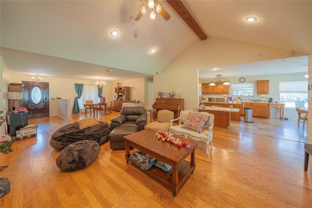 living room featuring ceiling fan, beamed ceiling, high vaulted ceiling, and light wood-type flooring