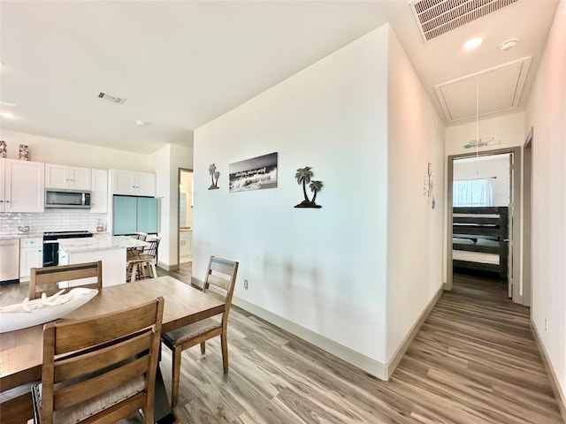 dining space with light wood-type flooring