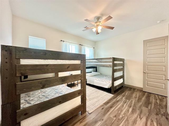 bedroom with ceiling fan and hardwood / wood-style flooring