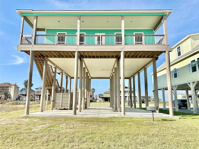 rear view of property featuring a lawn