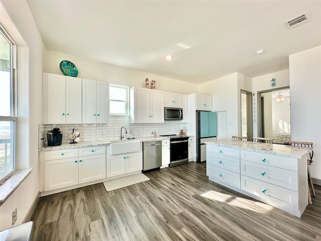 kitchen featuring light hardwood / wood-style floors, sink, white cabinetry, and stainless steel appliances