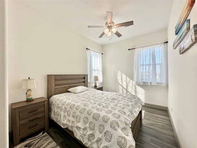 bedroom with ceiling fan and dark hardwood / wood-style flooring