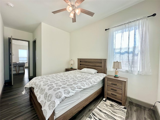 bedroom featuring ceiling fan and dark wood-type flooring