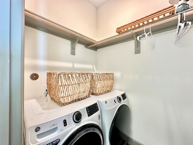 clothes washing area with washer and clothes dryer