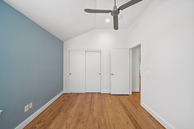 unfurnished bedroom featuring ceiling fan, lofted ceiling, and light hardwood / wood-style flooring