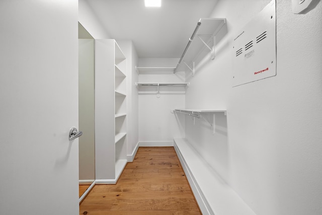 spacious closet with light hardwood / wood-style flooring