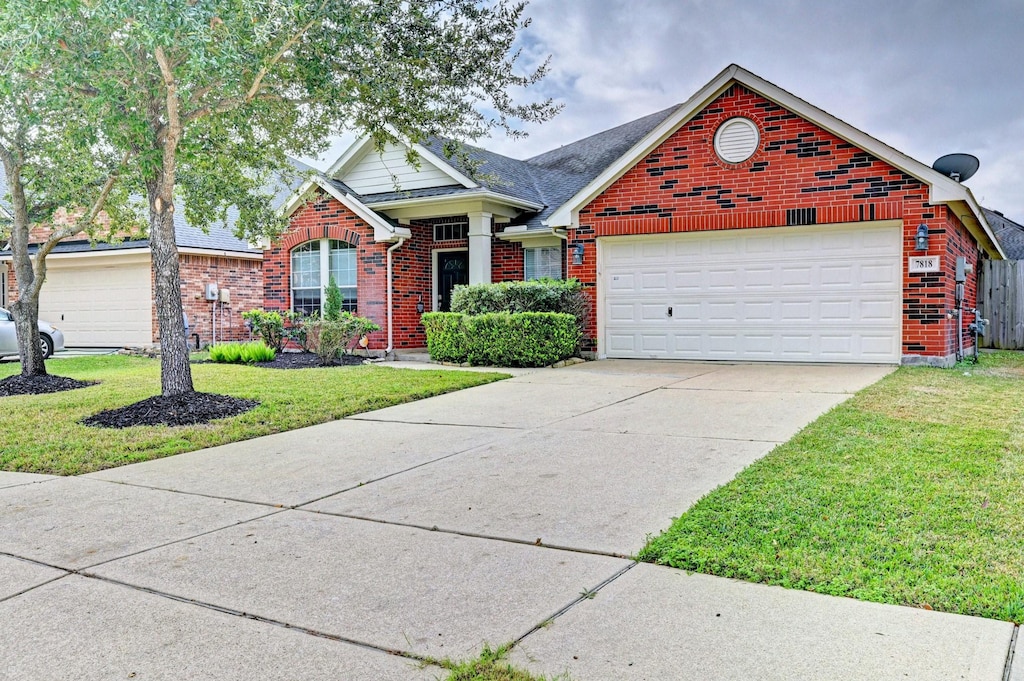 view of front of home featuring a garage and a front lawn