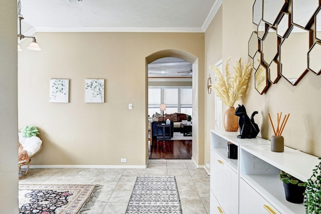 hall featuring crown molding and light tile patterned flooring