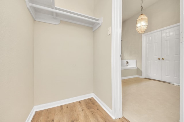 walk in closet with hardwood / wood-style flooring