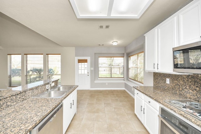 kitchen featuring stone counters, white cabinetry, sink, and stainless steel appliances