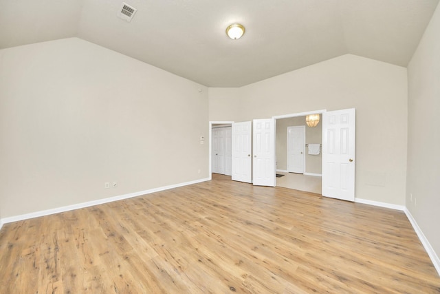 unfurnished bedroom featuring light hardwood / wood-style floors and vaulted ceiling