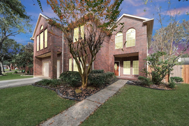 view of front of house featuring a yard and a garage