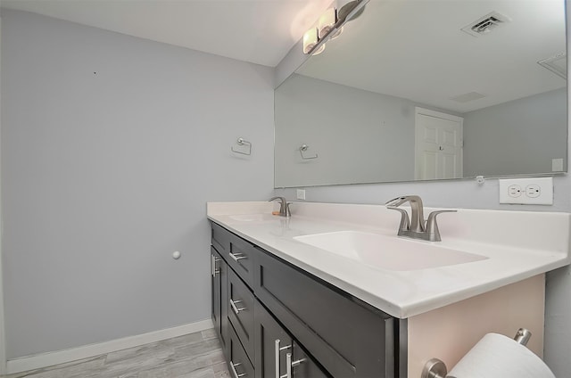 bathroom with hardwood / wood-style floors and vanity