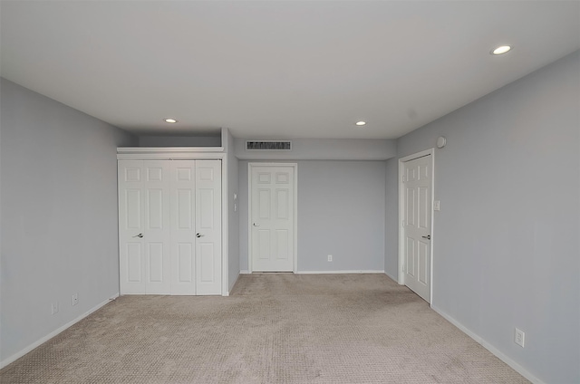 unfurnished bedroom featuring light carpet