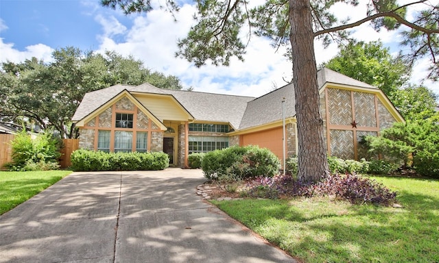 view of front facade with a front yard and a garage