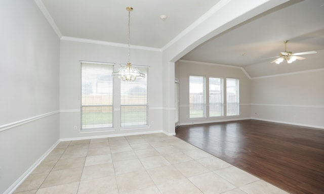 unfurnished room with ceiling fan with notable chandelier, light tile patterned floors, crown molding, and vaulted ceiling