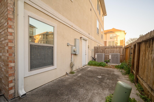 view of property exterior featuring a patio and central AC