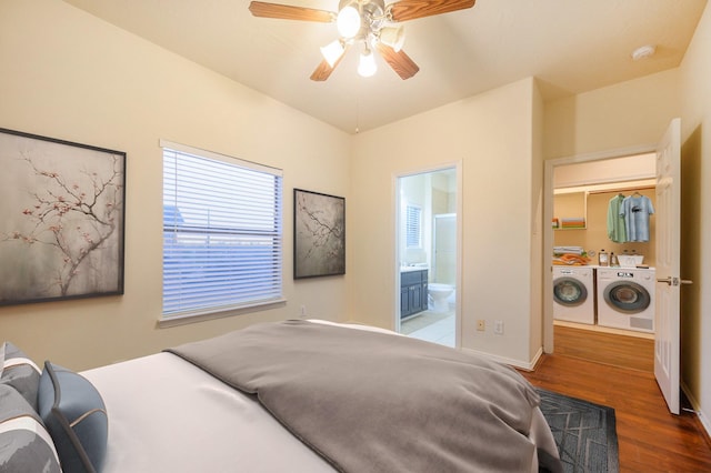 bedroom with independent washer and dryer, ensuite bath, ceiling fan, and dark wood-type flooring