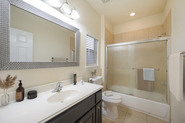 full bathroom featuring vanity, toilet, tile patterned flooring, and combined bath / shower with glass door